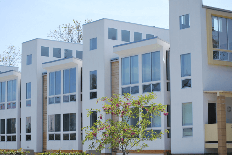 Exterior of a large condo building with two stories visible